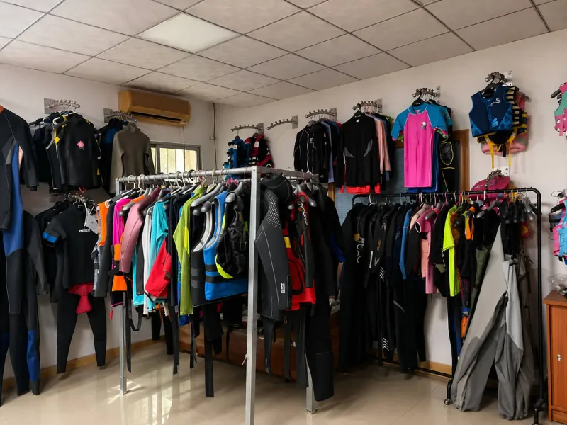 Reference wetsuit samples hanging in the INSEAKU sample room