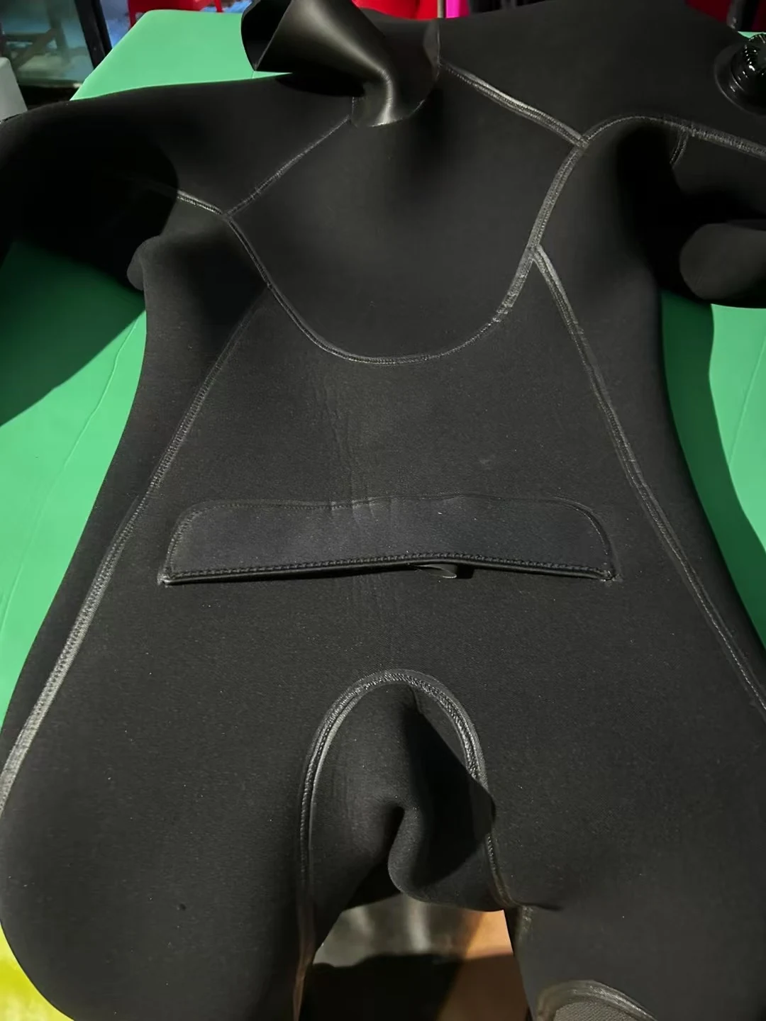Black Smooth Finish Suit with Reinforced Panels, chest detail.