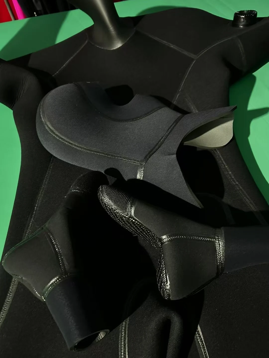 Black Smooth Finish Suit with Reinforced Panels, neck seal detail.