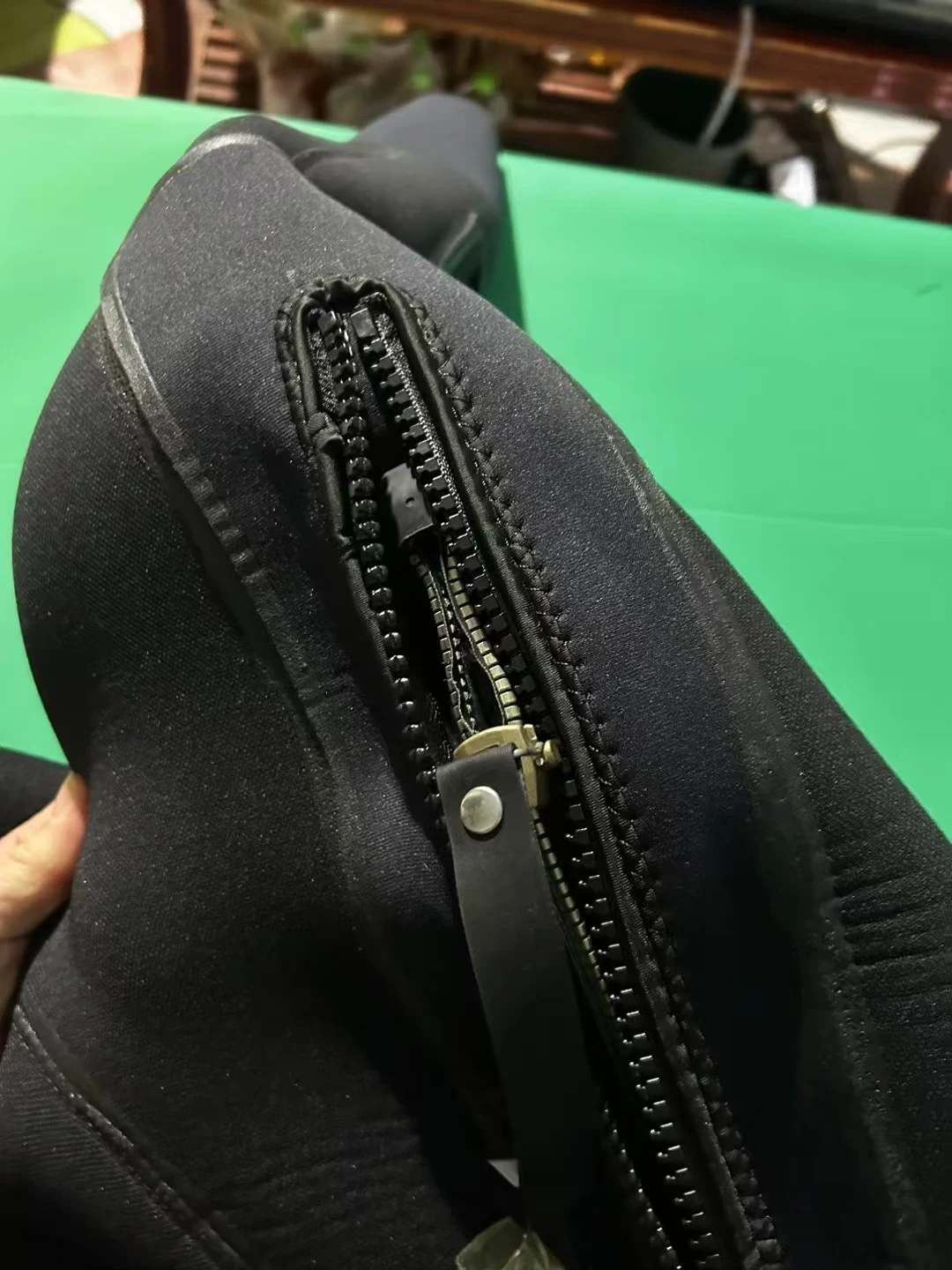 Black Smooth Finish Suit with Reinforced Panels, zipper end detail.