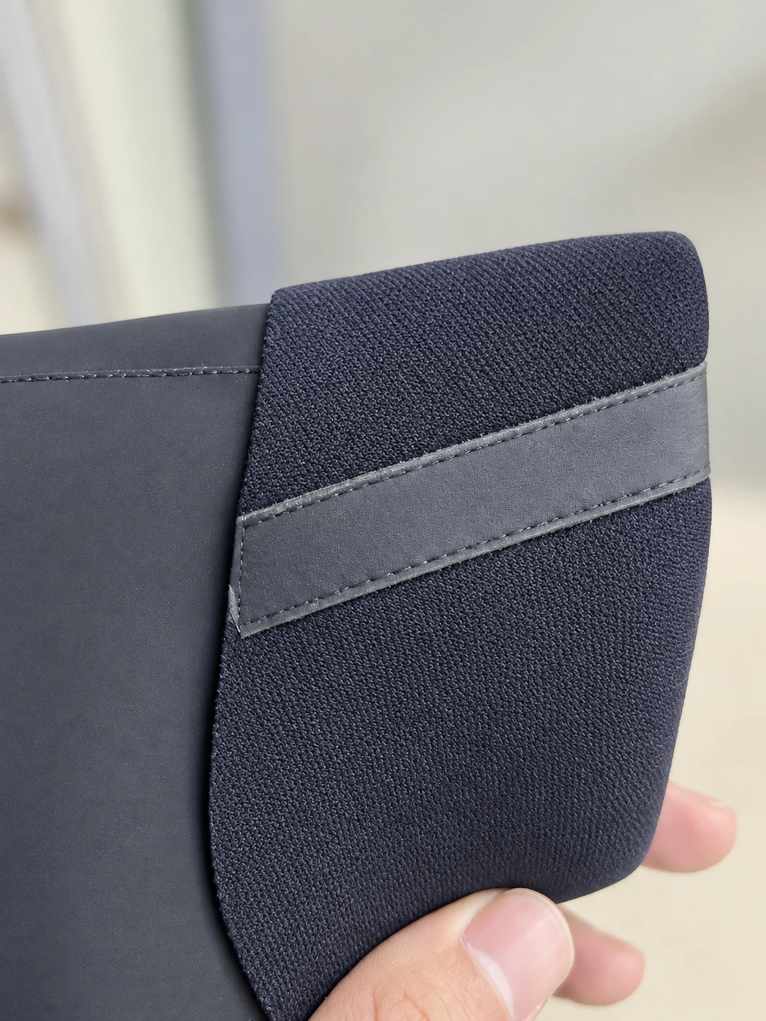 A folded cuff showing inner fabric and joining strip. Detail of the INSEAKU orange pattern sleeve triathlon wetsuit.